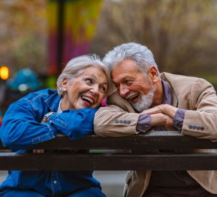 Elderly couple smiling at each other